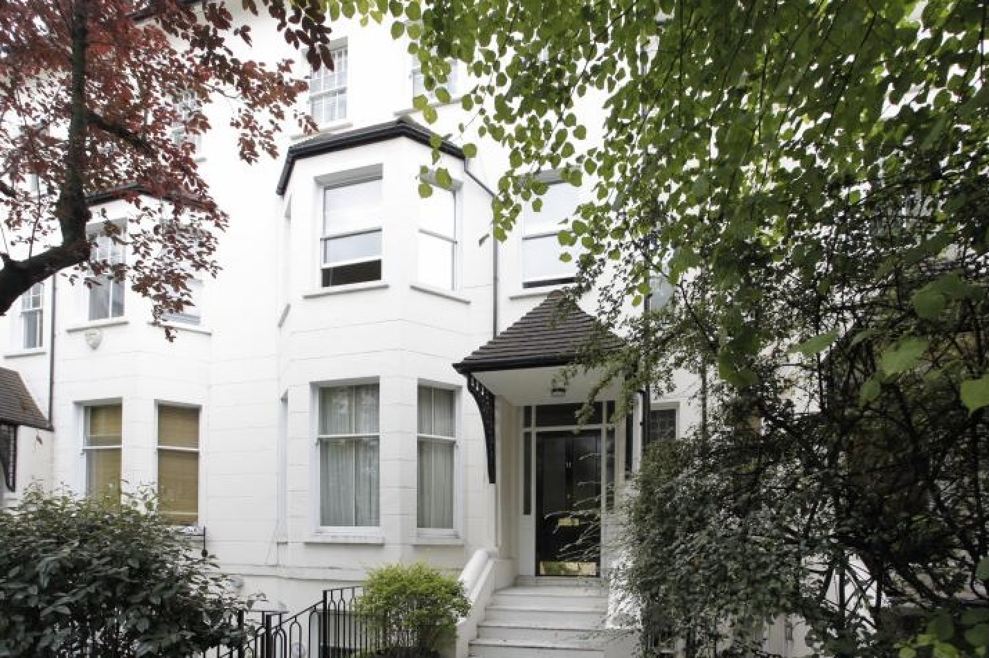 Front exterior of the white-painted Victorian villa at Abbey Road, St John's Wood NW8 — short-let listing.